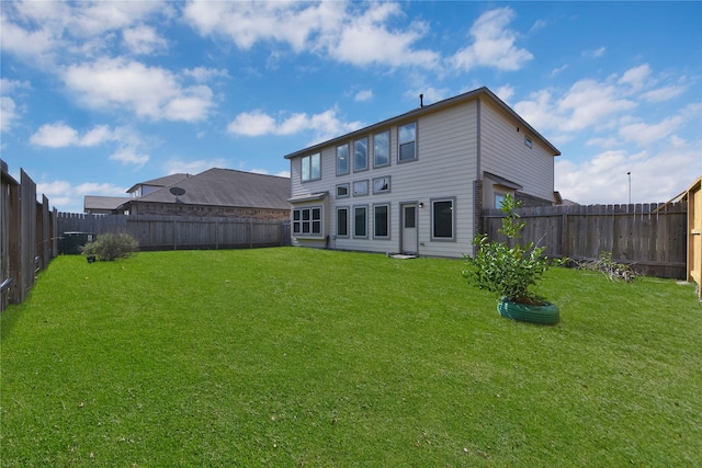 rear view of house with a lawn