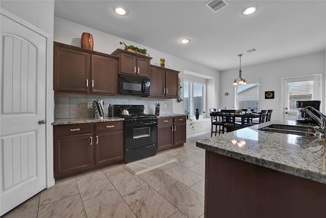 kitchen with black appliances, dark brown cabinets, sink, and a wealth of natural light