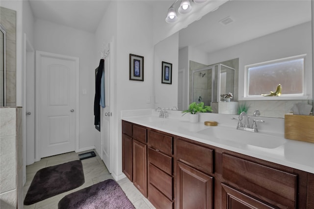 bathroom with tile patterned floors, a shower with door, and vanity