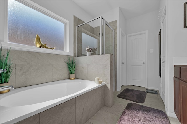 bathroom with tile patterned flooring, vanity, and independent shower and bath