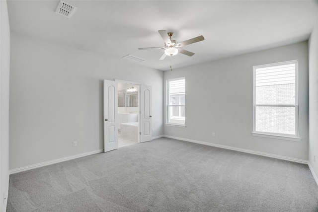 empty room featuring ceiling fan and light colored carpet