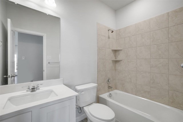 full bathroom featuring vanity, tiled shower / bath combo, and toilet