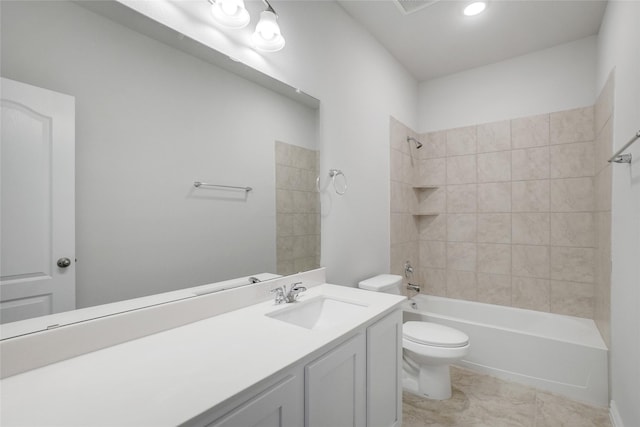 full bathroom featuring tiled shower / bath, vanity, and toilet