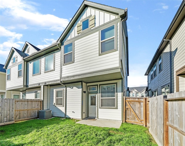 back of house featuring a yard, a patio, and central AC unit