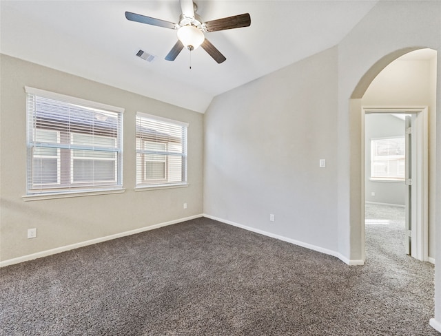 carpeted spare room featuring ceiling fan and vaulted ceiling