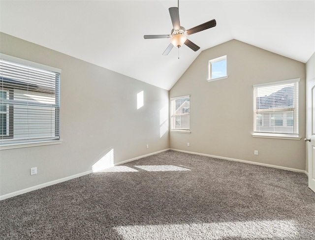 spare room featuring ceiling fan, carpet, and lofted ceiling