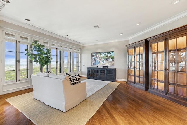 living room with hardwood / wood-style floors and crown molding