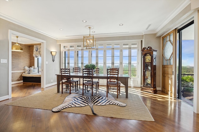 dining area featuring a chandelier, dark hardwood / wood-style floors, and ornamental molding