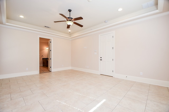 unfurnished room with light tile patterned floors, a tray ceiling, ceiling fan, and crown molding