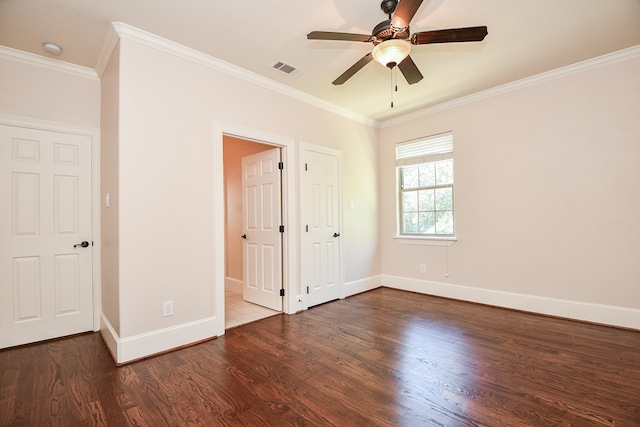 unfurnished bedroom with dark hardwood / wood-style flooring, ceiling fan, and crown molding