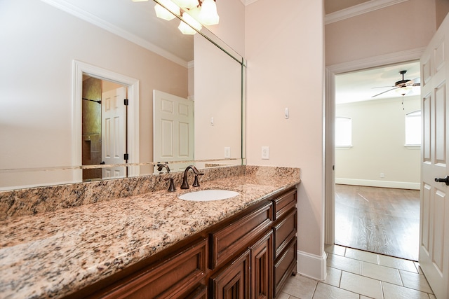 bathroom with ceiling fan, hardwood / wood-style floors, vanity, and ornamental molding