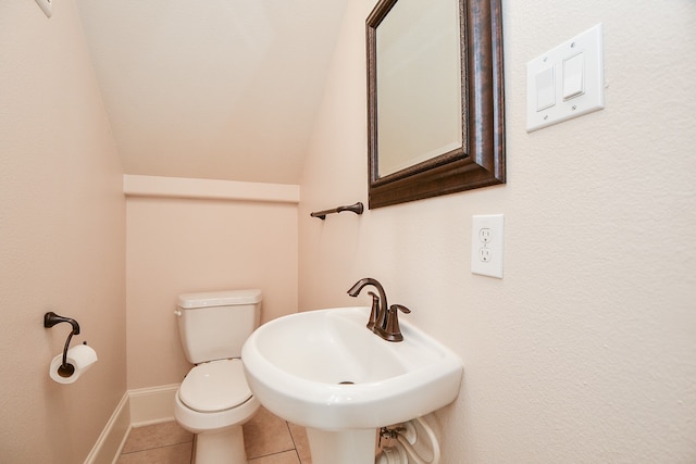 bathroom featuring tile patterned flooring, toilet, and sink