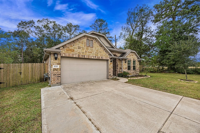 view of front of house with a front yard and a garage