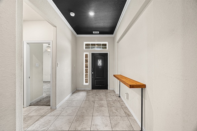 foyer entrance featuring light tile patterned floors, a textured ceiling, ceiling fan, and crown molding