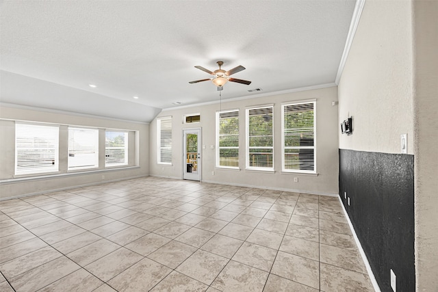 unfurnished living room with light tile patterned floors, a textured ceiling, ceiling fan, and ornamental molding