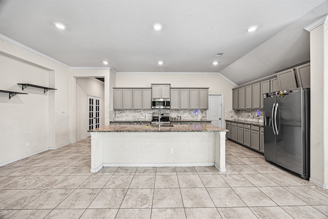 kitchen featuring gray cabinets, a kitchen island with sink, stainless steel appliances, and lofted ceiling