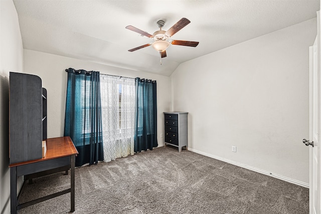 interior space with dark colored carpet, ceiling fan, a textured ceiling, and vaulted ceiling