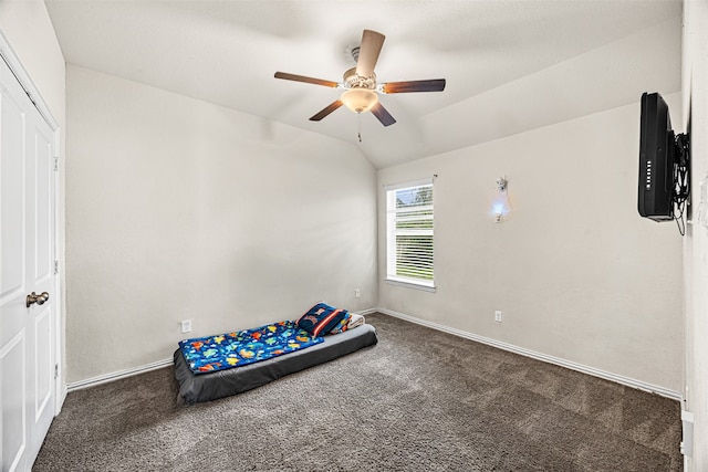 unfurnished bedroom with ceiling fan, carpet, and vaulted ceiling