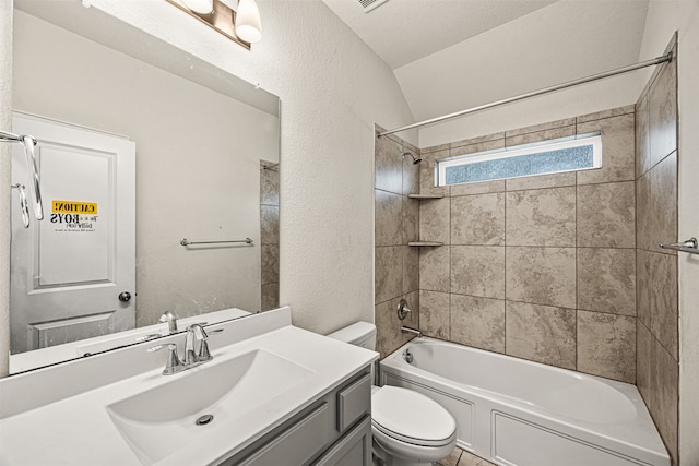 full bathroom with a textured ceiling, vanity, toilet, tiled shower / bath, and lofted ceiling