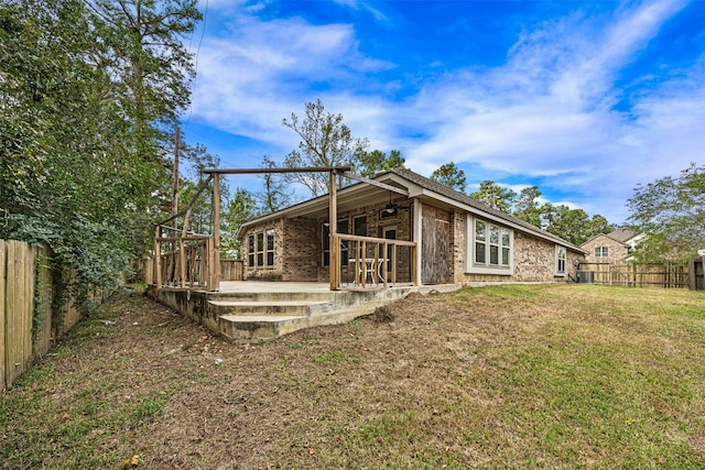 rear view of house with a patio area and a lawn