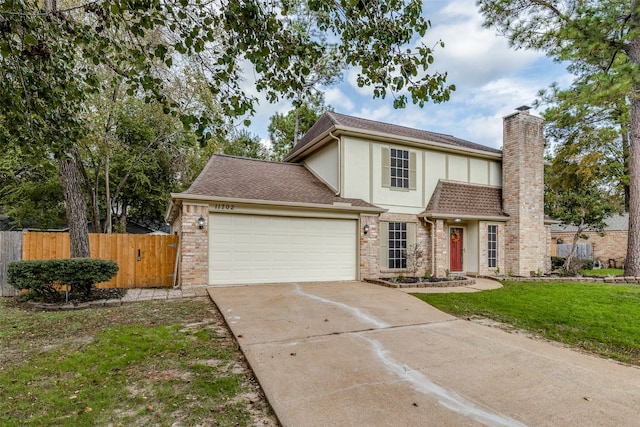 view of front of home featuring a garage and a front yard