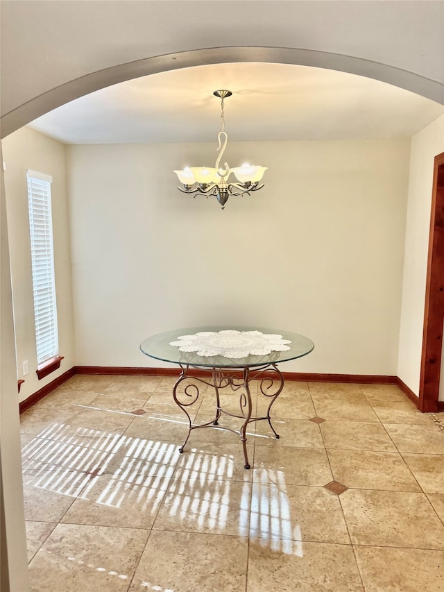 unfurnished dining area with a notable chandelier