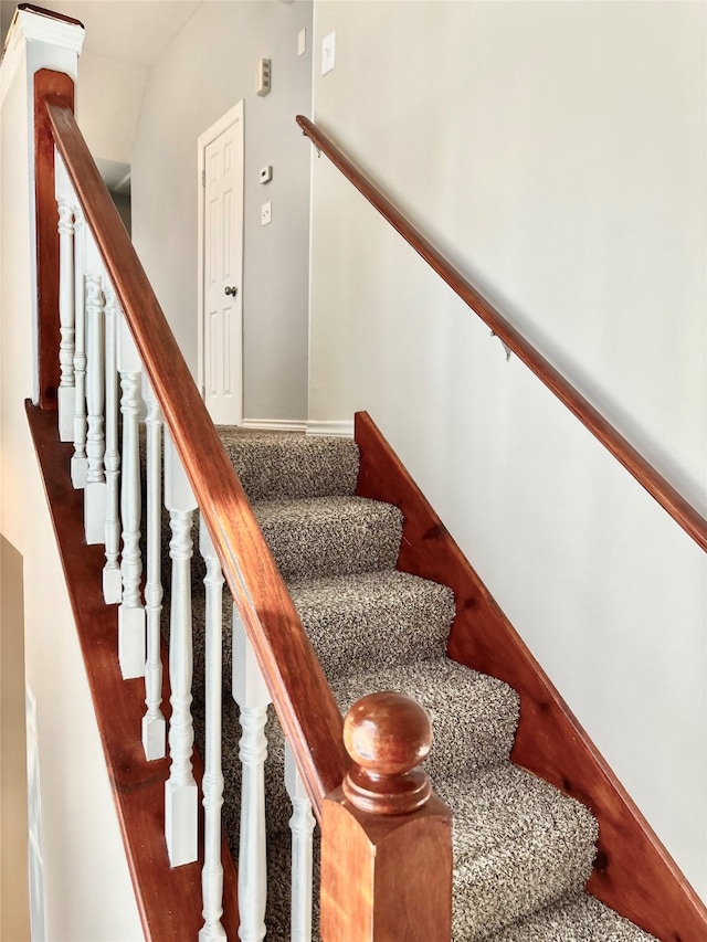 stairway with vaulted ceiling