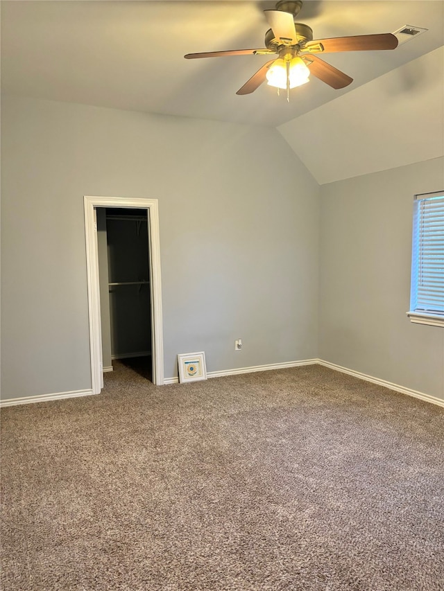 unfurnished bedroom with ceiling fan, carpet, and vaulted ceiling