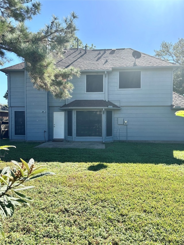 rear view of property with a yard