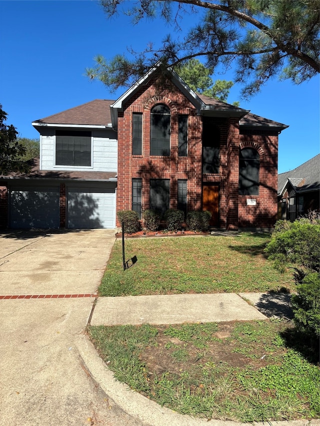 view of front of house with a garage and a front yard