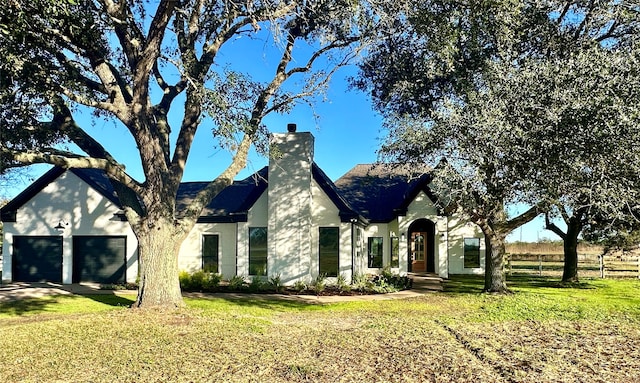 view of front facade featuring a front yard and a garage