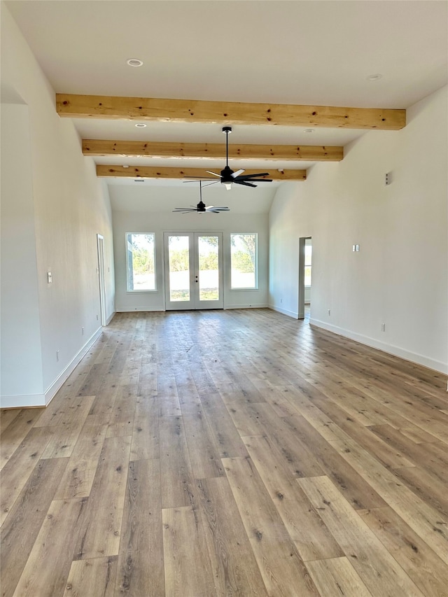 unfurnished living room with french doors, lofted ceiling with beams, light hardwood / wood-style flooring, and ceiling fan