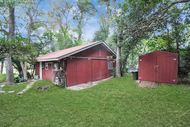 view of outbuilding featuring a yard