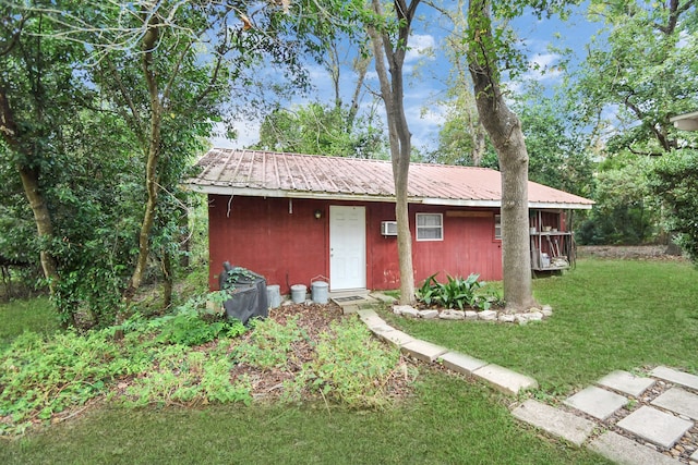 view of outbuilding with a yard