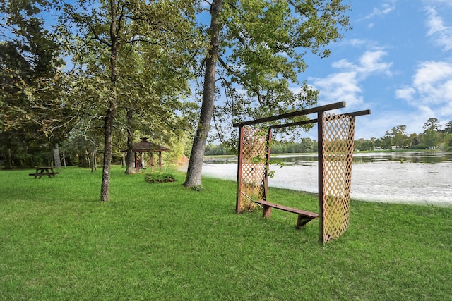 view of yard featuring a gazebo and a water view