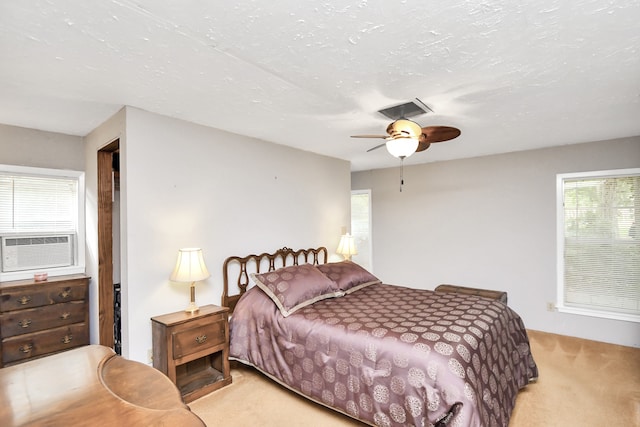 bedroom with ceiling fan, cooling unit, and light colored carpet