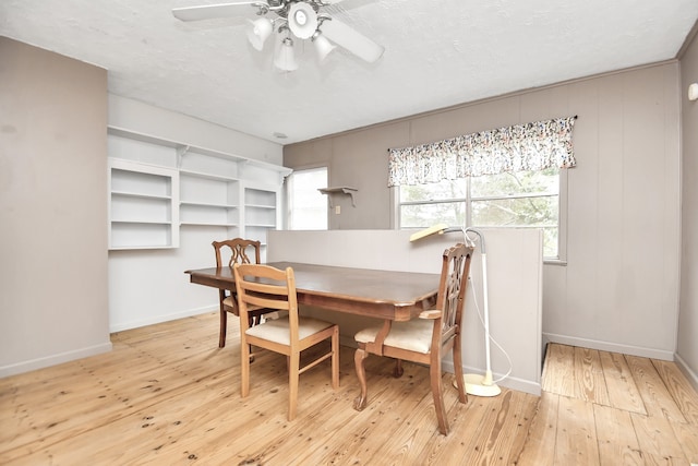 dining room with light hardwood / wood-style flooring and ceiling fan