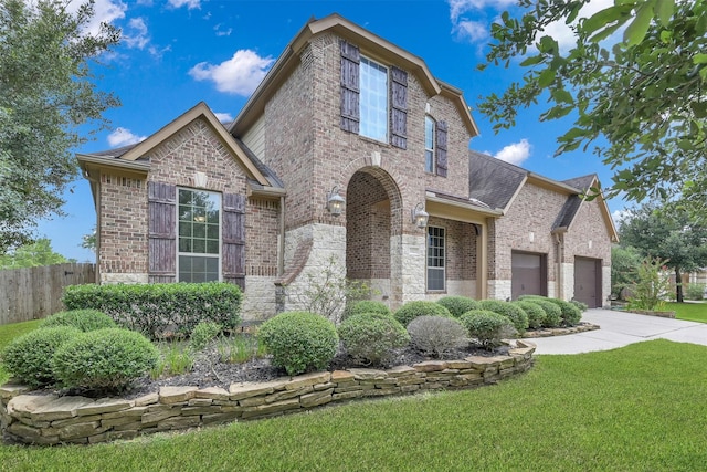 view of front of home with a front lawn and a garage