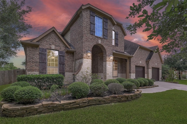 view of front of house featuring a garage and a yard