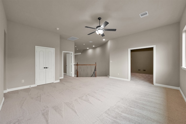 carpeted spare room featuring ceiling fan