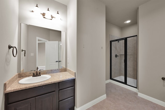 bathroom featuring a shower with door, vanity, and tile patterned flooring