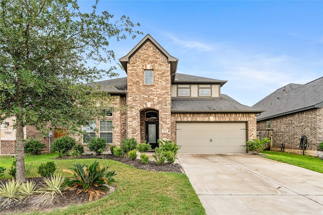 view of front of home featuring a garage and a front yard