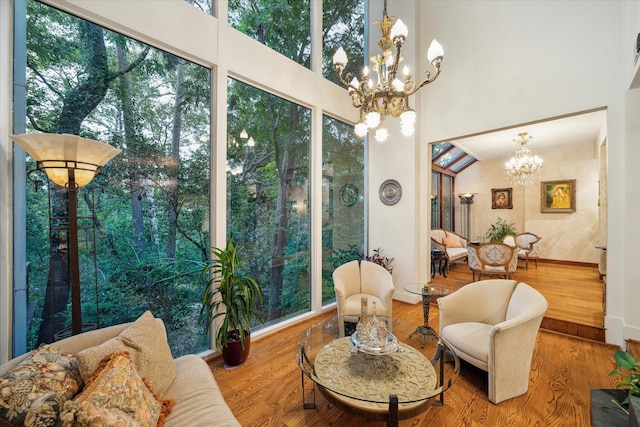 45 Briar Hollow Ln Unit 4, Houston, TX 77027 - sitting room with a chandelier, wood finished floors, healthy amount of natural light, and a towering ceiling