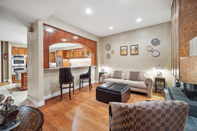 45 Briar Hollow Ln Unit 4, Houston, TX 77027 - living room with recessed lighting, light wood finished floors, and arched walkways