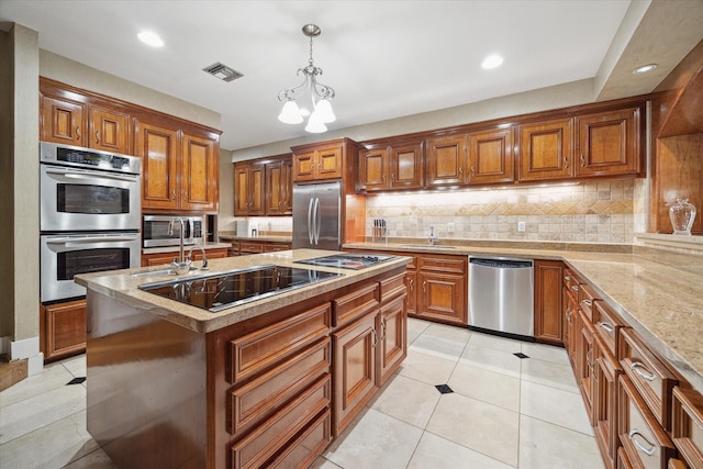 45 Briar Hollow Ln Unit 4, Houston, TX 77027 - kitchen with stainless steel appliances, brown cabinetry, tasteful backsplash, pendant lighting, and a kitchen island with sink