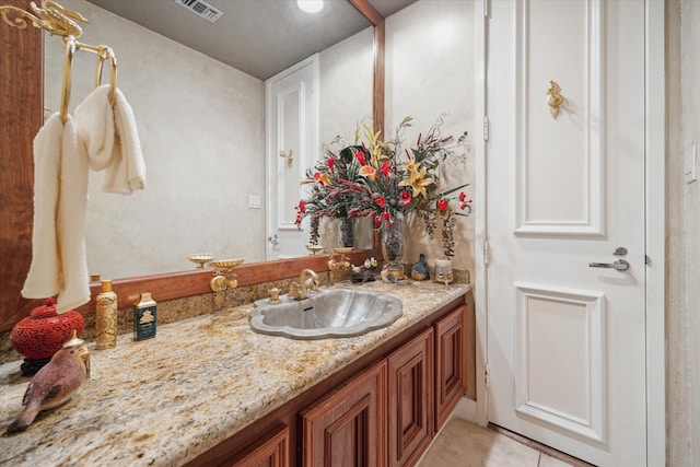 bathroom featuring tile patterned flooring and vanity