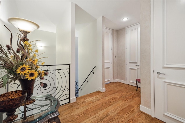 45 Briar Hollow Ln Unit 4, Houston, TX 77027 - hall with an upstairs landing, light wood-type flooring, and recessed lighting