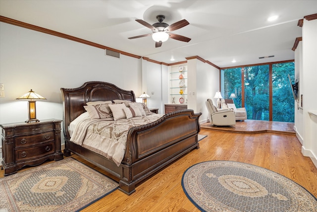 bedroom with ceiling fan, access to exterior, light wood-type flooring, and ornamental molding