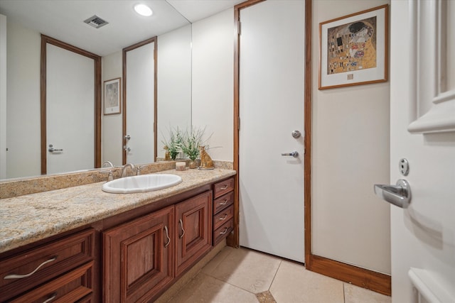 bathroom with tile patterned flooring and vanity