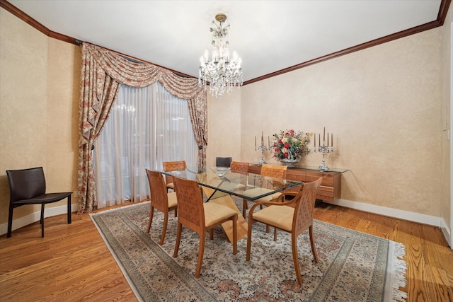 45 Briar Hollow Ln Unit 4, Houston, TX 77027 - dining room with crown molding, a chandelier, and light wood finished floors